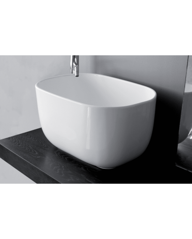 Lavabo Bowl 1 Bleu Provence en céramique blanche, design ovale, posé sur plan en bois sombre.